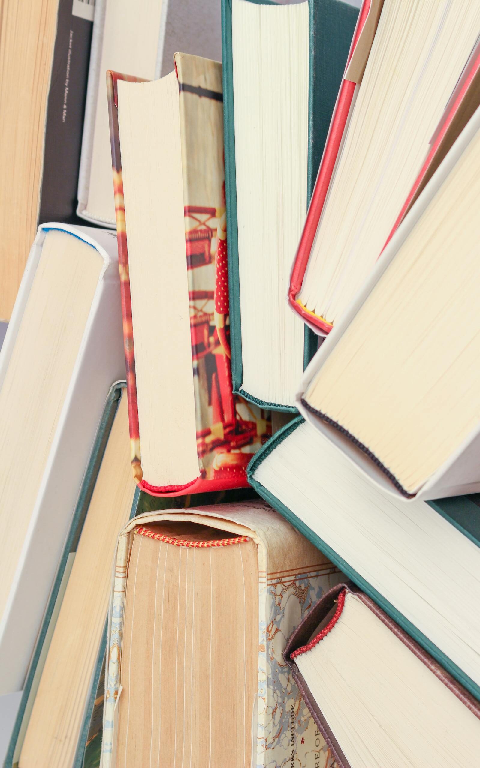 A vibrant collection of hardcover books with colorful covers viewed from above.